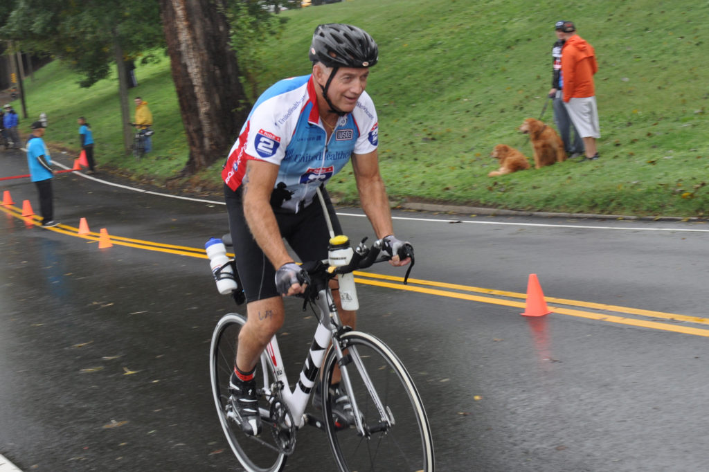Greg White, president and CEO, Northern Neck Electric Cooperative, climbs a hill on his bicycle during the 2015 Richmond Triathlon.