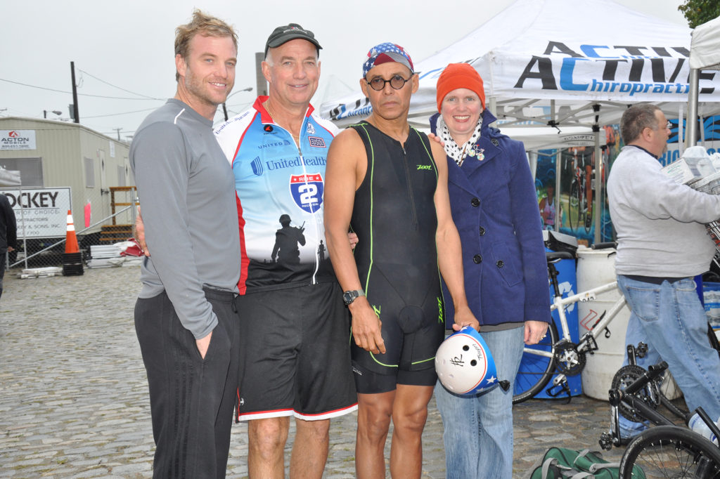 Casey White, Greg White, Humberto Reyna, and his wife, Kay pose prior to the start of the 2015 Richmond Triathlon.