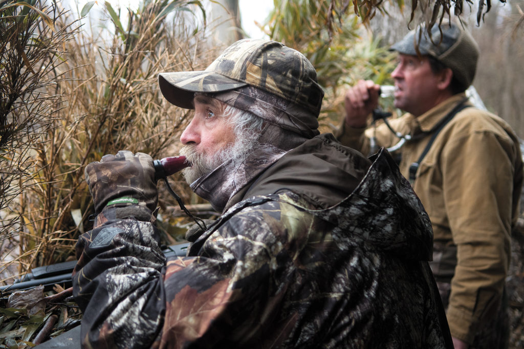 Clint McGowan, left, and Clay Bullard work hard to call in a nearby flock of ducks. 
