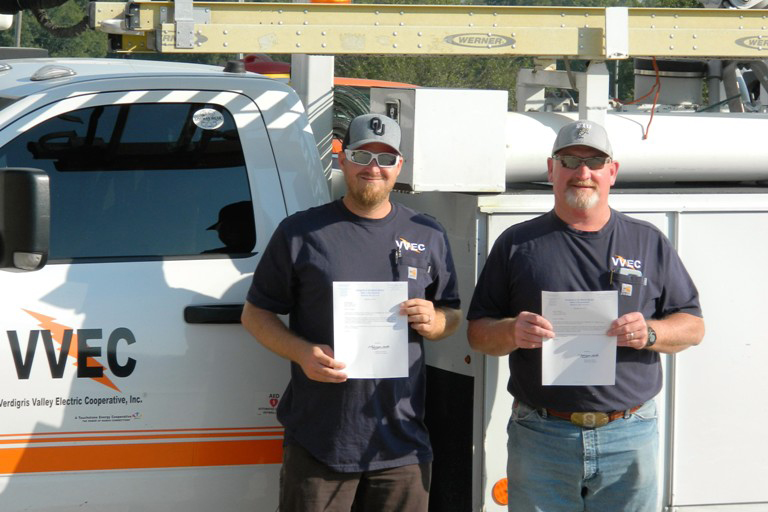 (L-R) Lineworkers Ricky Rimpley and Roger Salisbury hold letters of recognition from U.S. Rep. Markwayne Mullin. (Photo By: VVEC)