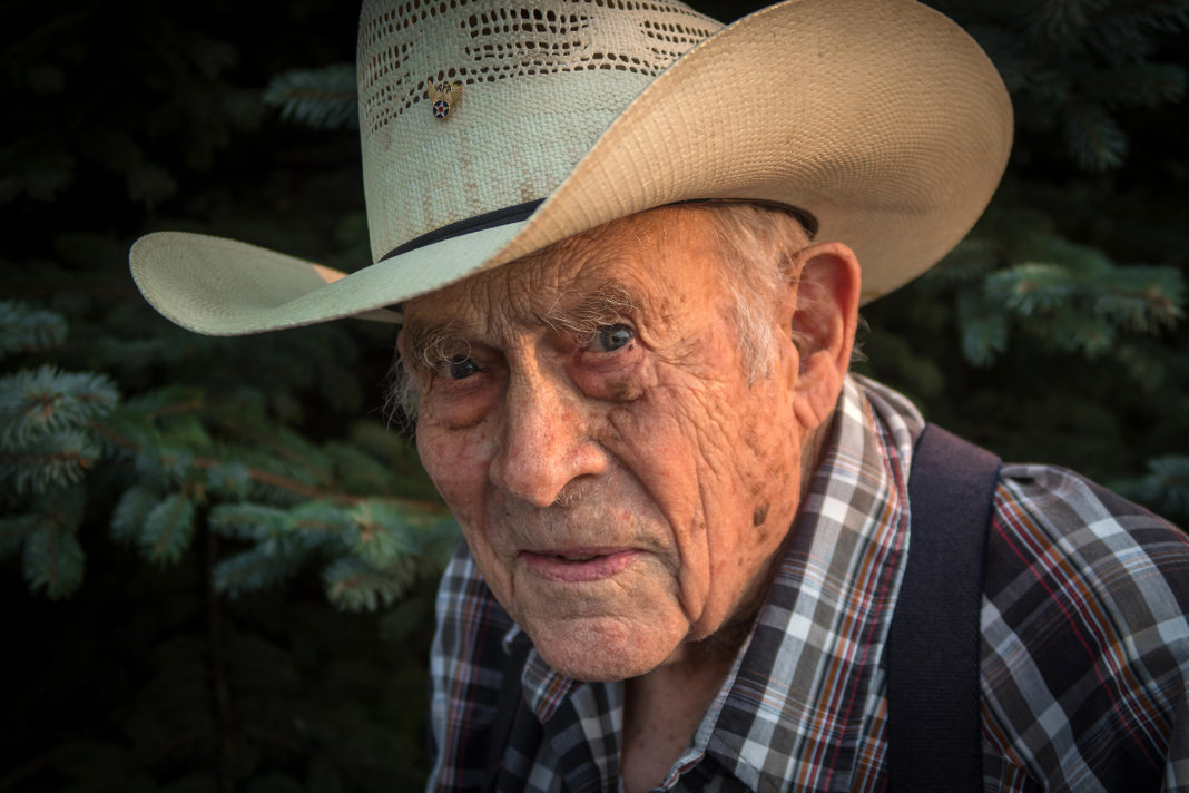 World War II veteran John Wheelihan, 99, at his farm in Ellendale, N.D. He still drives the 50-mile roundtrip to annual meetings at Dakota Valley EC. (Photo By: Roddy MacInnes)