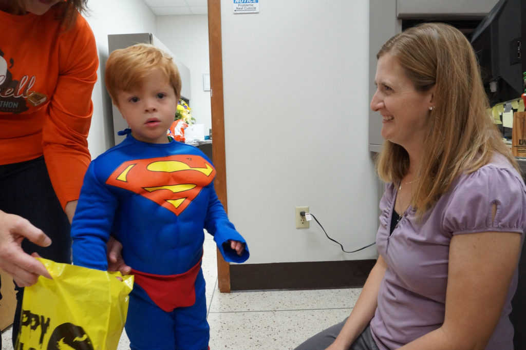 Superman Brody Bax takes a break from trick or treating at Central Electric Power Co-op with Ann Schulte. (Photo By: Kim McKague)