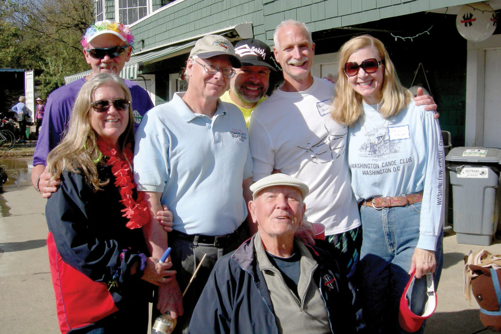 Dan (left, rear) and Bonnie Havens, Dodge Havens, Blaise Rhodes, Keith Havens, and Priscilla Knight surround Frank Havens at Frank Havens Regatta at the Washington Canoe Club. (Photo Courtesy: Priscilla Knight)