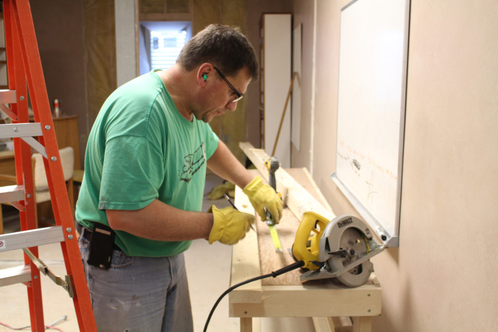 Dakota Gasification Company’s Dale Johnson takes the lead on remodeling the kitchen for the new day care co-op in Hazen, N.D. (Photo Courtesy of Basin Electric)