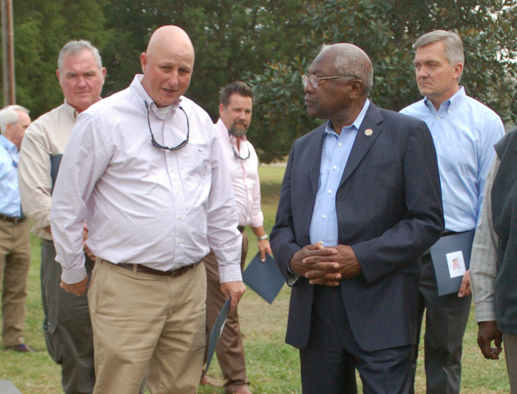 Santee Electric’s Jay Kirby (left) tells Rep. Jim Clyburn about the new heat pump and other energy efficiency measures made to Martha Scott’s home by “Help My House” program,with NRECA CEO Jim Matheson at right. (Photo By: Walter Allread, South Carolina Living)