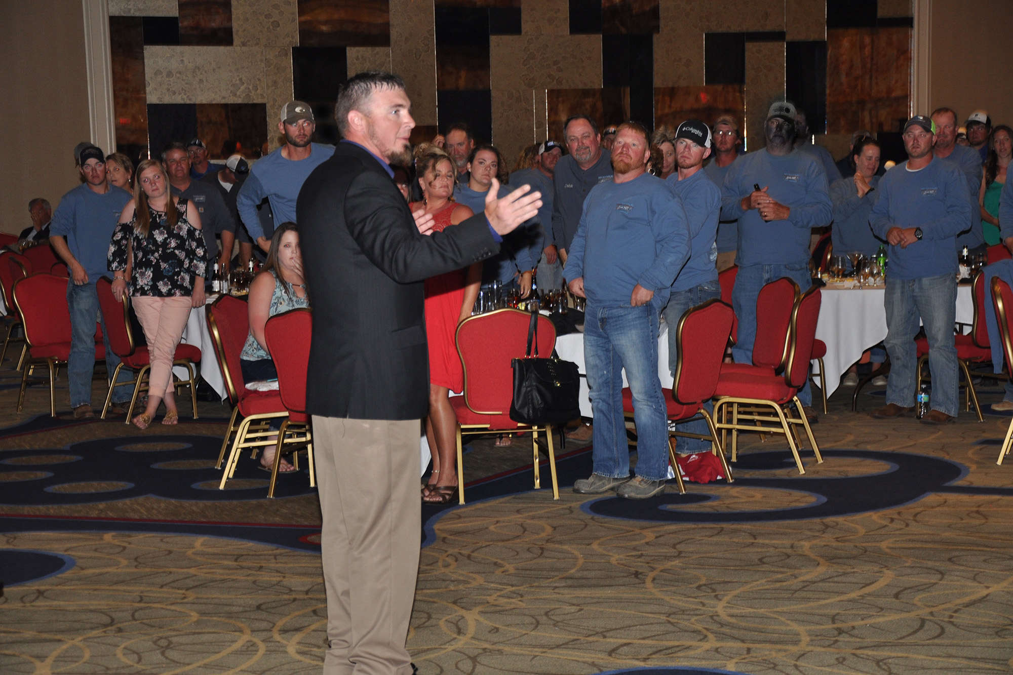 Fellow linemen stand during Nate Humphrey's presentation at the Gaff-n-Go Rodeo. (Photo By: Bill Sherrod/VMDAEC)