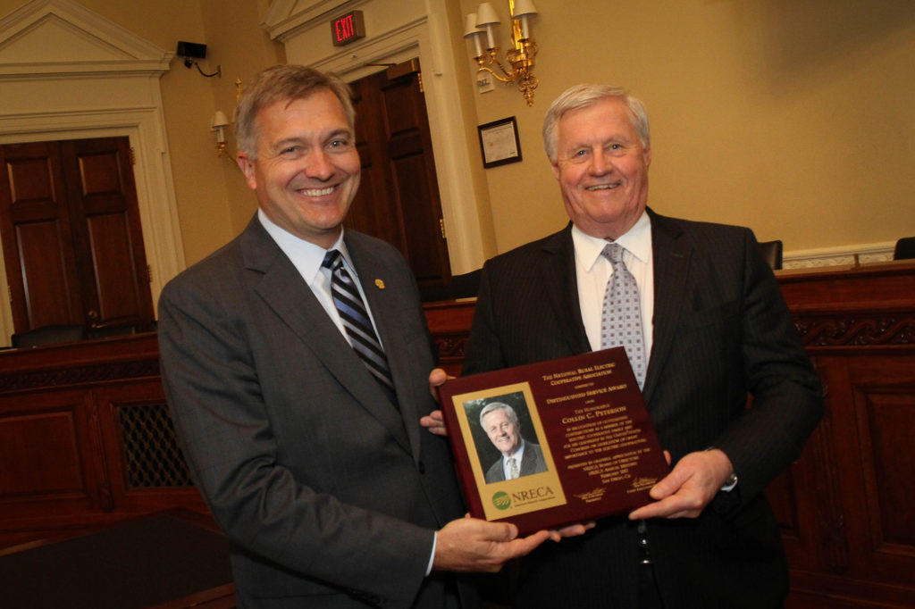 NRECA CEO Jim Matheson (r) recognizes Rep. Collin Peterson, D-Minn., with the NRECA Distinguished Service Award for his stalwart support of co-ops. (Photo By: Luis Gomez Photos)