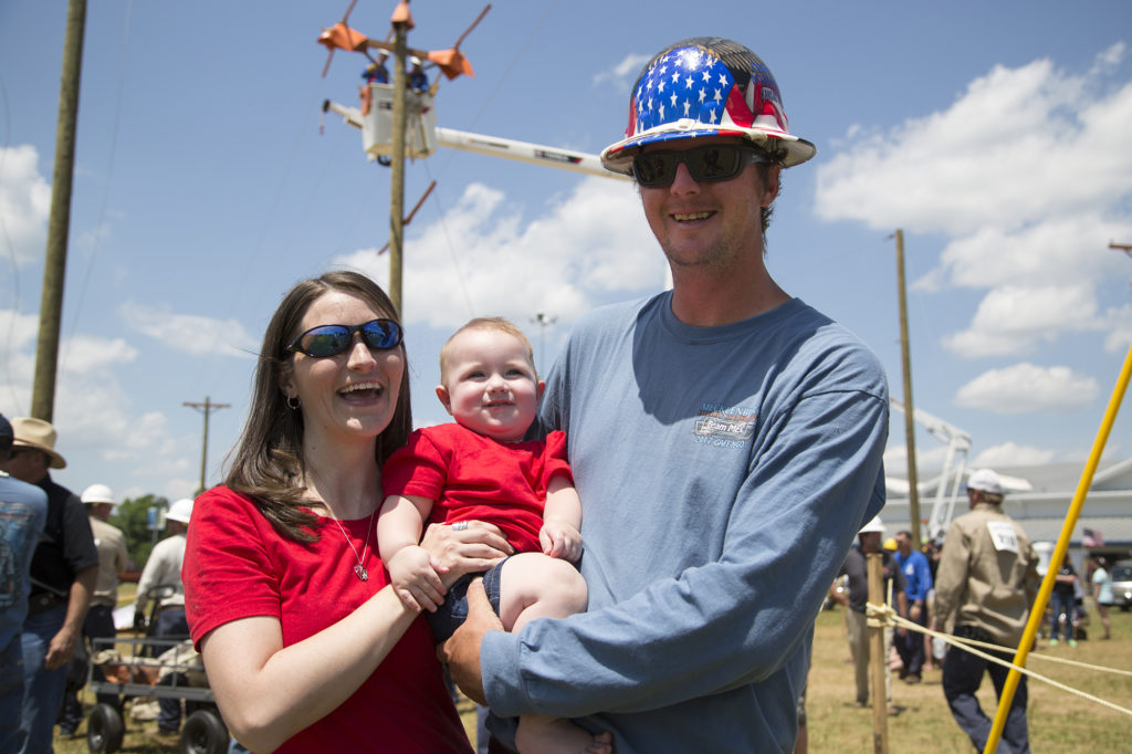 Brad Clark of Mecklenburg Electric Cooperative and his wife Heather are with son Bryce during the annual Gaff-n-Go Lineman’s Rodeo, which drew about 150 competitors to a site north of Richmond, Virginia. (Photo By: Denny Gainer)