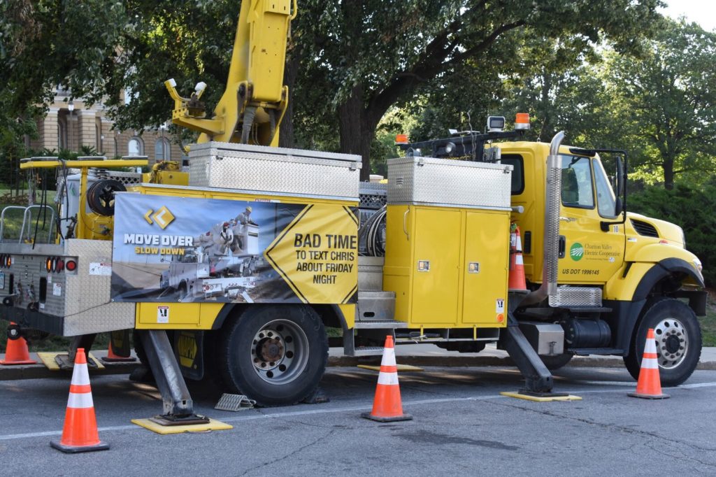 A sign on the side of an electric co-op truck informs motorists of the state's "Move Over" law. (Photo by Iowa Association of Electric Cooperatives)