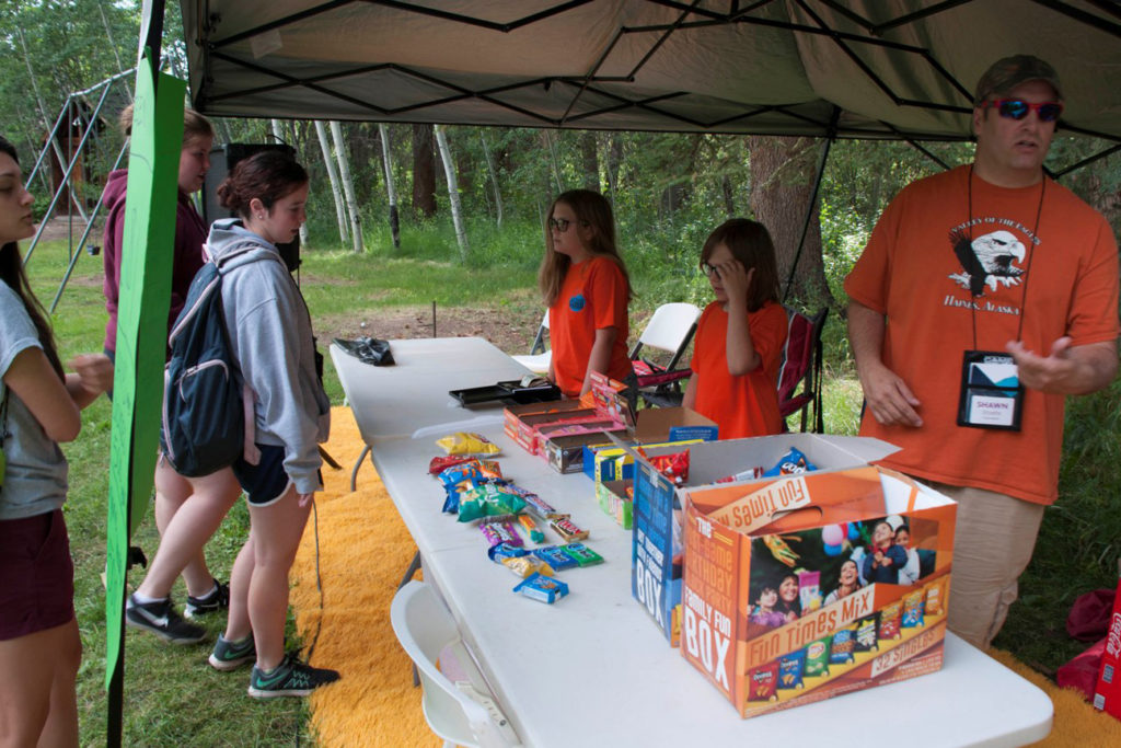 Campers decide what they’d like to buy from the “canteen” with the capital credits going to NRECA International. (Photo By: Shana Read)