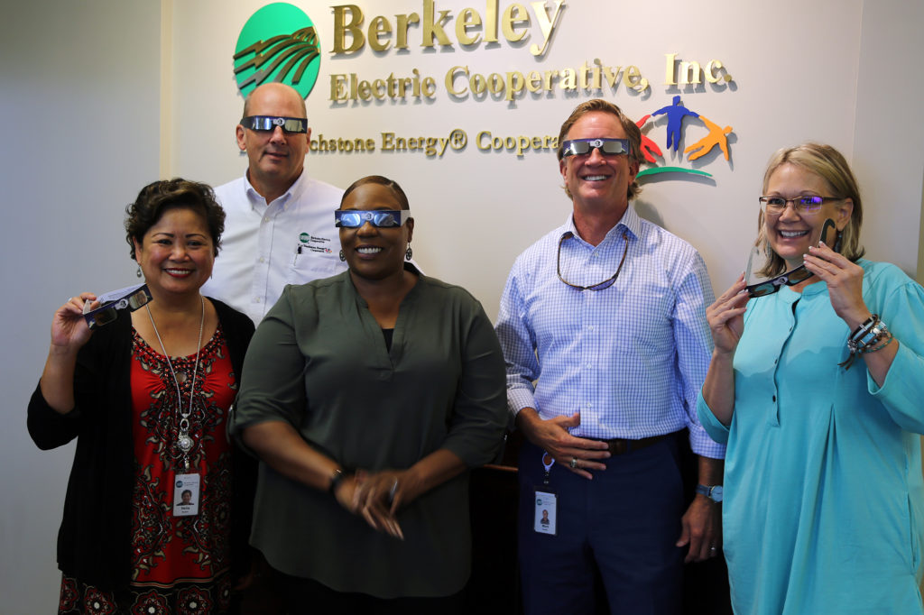 Berkeley Electric Co-op employees show off the some 2,000 pairs of eclipse-ready glasses given to co-workers, retirees and the public. (Photo By: Micah Ponce)