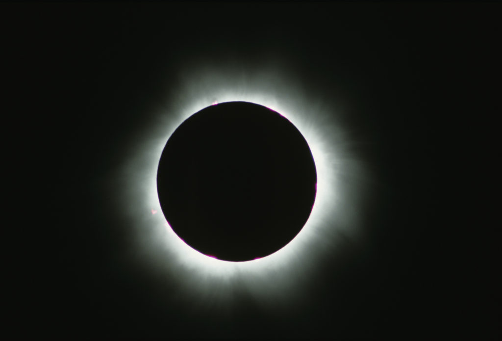 Rays of sunlight emerge behind the moon as it eclipses the sun. A 70-mile wide path of totality will include 14 states and many electric co-op territories. (Photo By: Getty Images/iStockPhoto)