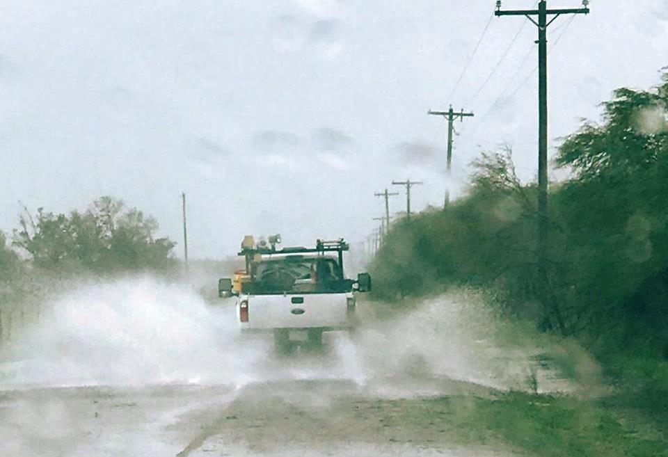 Crews splash through rain-slickened roads yo assess damage after Hurricane Harvey. (Photo By: Victoria Electric Co-op)