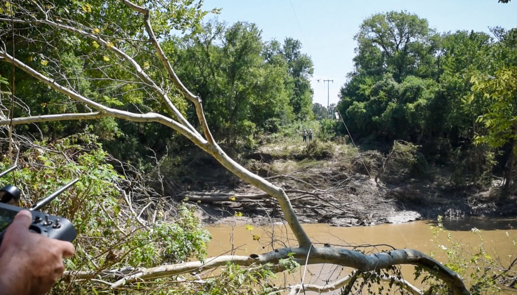 Bluebonnet Electric Co-op’s Ray Bitzkie flies a drone across the San Marcos River, the first time the co-op has used the aircraft after a natural disaster. (Photo By: Sarah Beal, Bluebonnet EC)