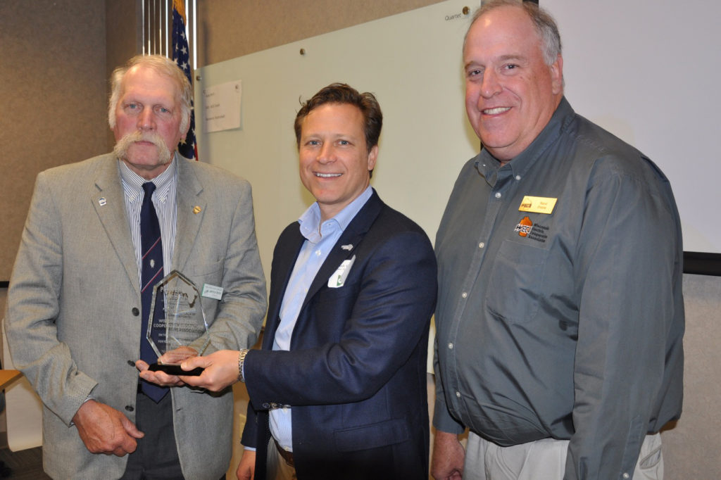 Power Africa’s Andrew Herscowitz (center) presents a token of appreciation to Larry Becker (left) of ACEC and Steve Freese of the Wisconsin statewide. (Photo By: Adams-Columbia Electric Cooperative)
