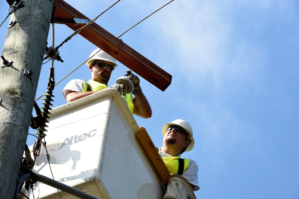 Dennis Woodcock (l), and Casey Allen of Laclede Electric Cooperative  help restore power for Flint Energies in Georgia after Hurricane Irma. (Photo By: Jim McCarty/Rural Missouri)