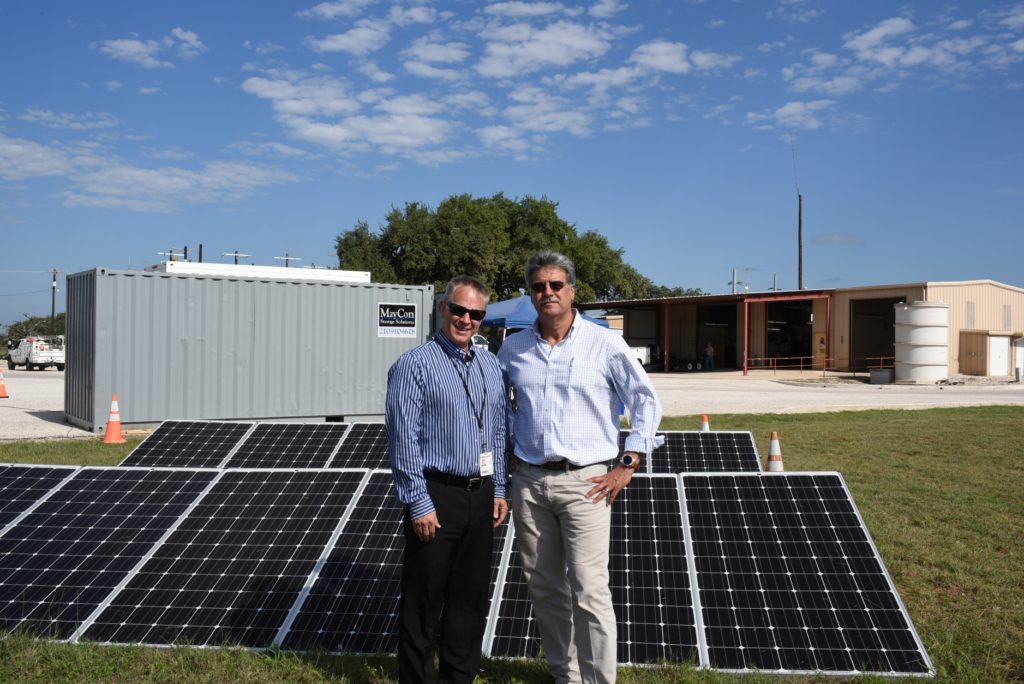 Bill Hetherington (left) and Dan Waddle stand with the solar panels that will travel to Liberia this fall. (Photo By: BEC)