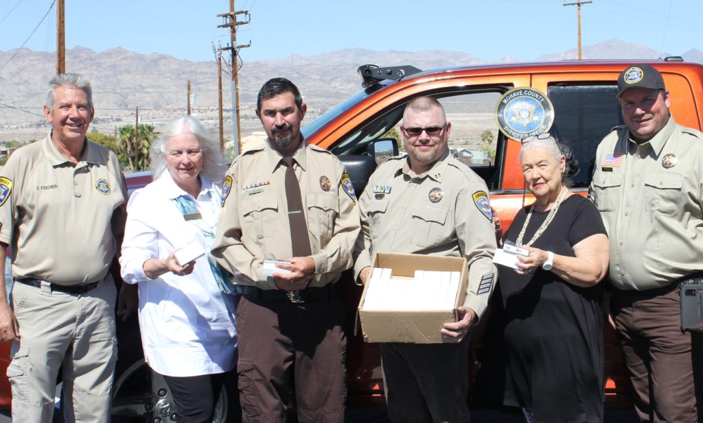 Mohave EC board members were on hand when volunteers from the local search and rescue unit accepted the donated power banks. (Photo By: Mohave EC)