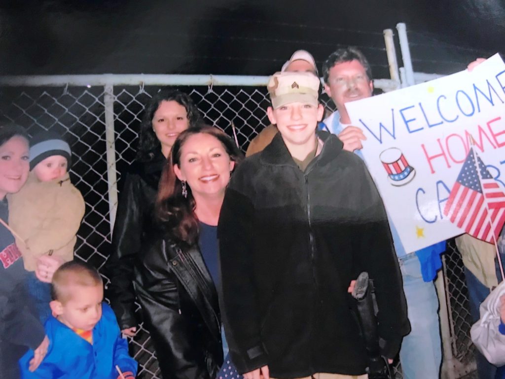 Staff Sgt. Carrie Goldstein is welcomed home in 2005 from a tour in Iraq by her mother, family and friends in Illinois. (Photo Courtesy of Carrie Goldstein)