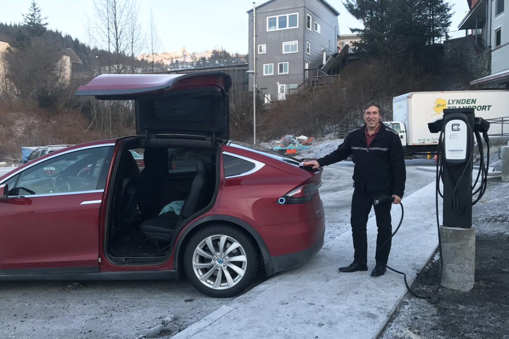 Cordova Electric Cooperative CEO Clay Koplin gets ready to plug in member John Harvill’s Tesla at one of the new charging stations. (Photo Courtesy of Clay Koplin)