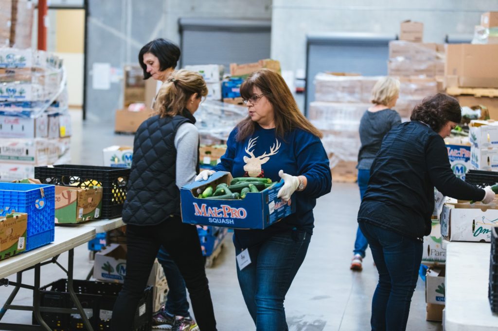 Participants in the Touchstone Energy® Cooperatives service project during CEO Close-Up help out at the FIND Food Bank. (Photo By: Stephen Reasonover)