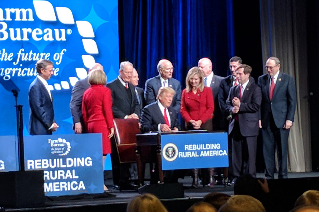 President Trump signs two executive orders to facilitate rural broadband after an address to the American Farm Bureau conference in Nashville. (Photo by: Mike Knotts)