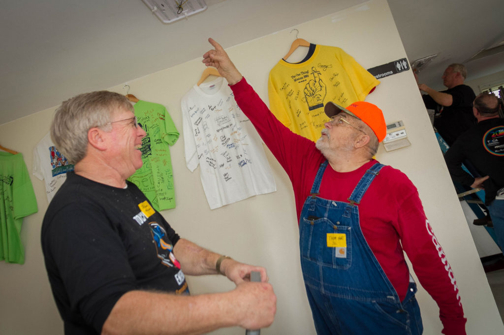 Jay Grove (left), president of the Adams Electric Cooperative board, shares a laugh with retired lineman Tom Hart while installing new LED fixtures. (Photo By: Luis Gomez Photos)