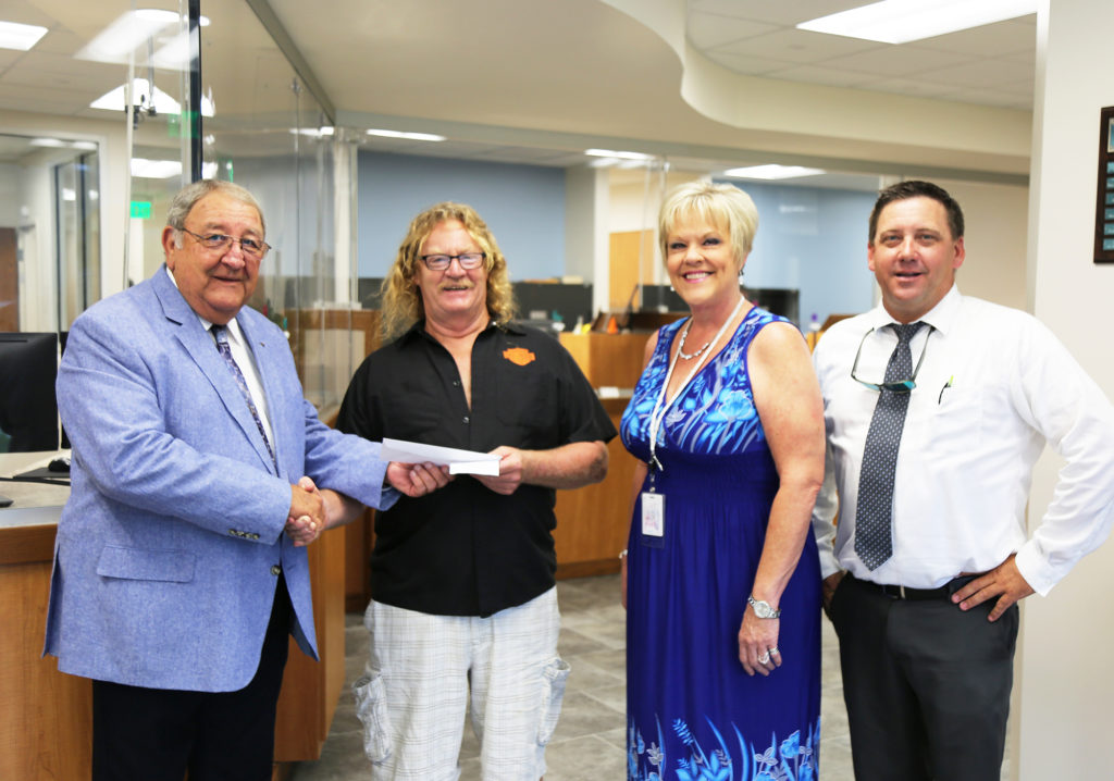 Clay Electric Cooperative member Mack Hiller was the first person served at the counter of the co-op’s new Salt Springs District Office. District manager Jim Beeler and his staff were there to help. (Photo By: Clay EC)