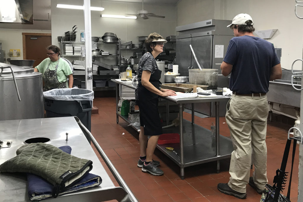 Myra Beasley, human resources director of Tideland EMC (center), runs a YMCA camp kitchen to help feed workers restoring power in the co-op’s service territory. (Photo By: Tideland EMC)