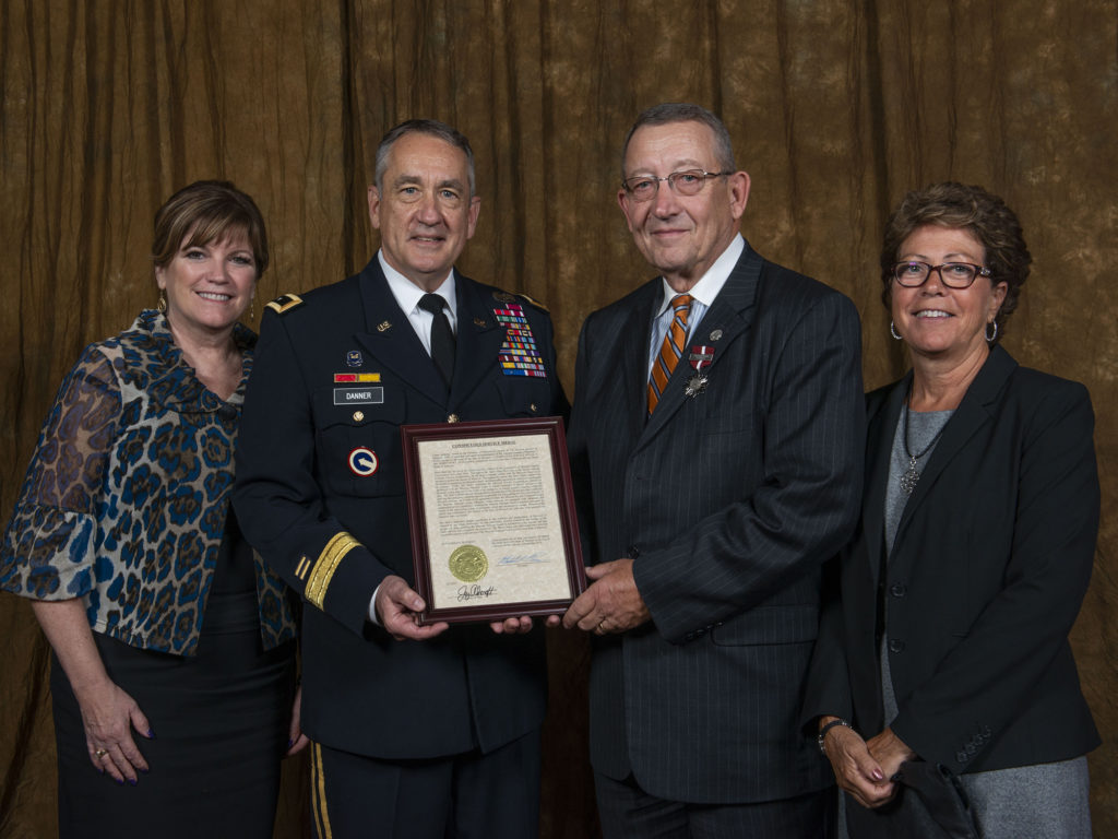 Adj. Gen. Steve Danner awards the Missouri Conspicuous Service Medal to AMEC’s Barry Hart for his commitment to the state. They’re pictured with their wives, Laura Hart and Kathleen Steele Danner. (Photo By: Rural Missouri)