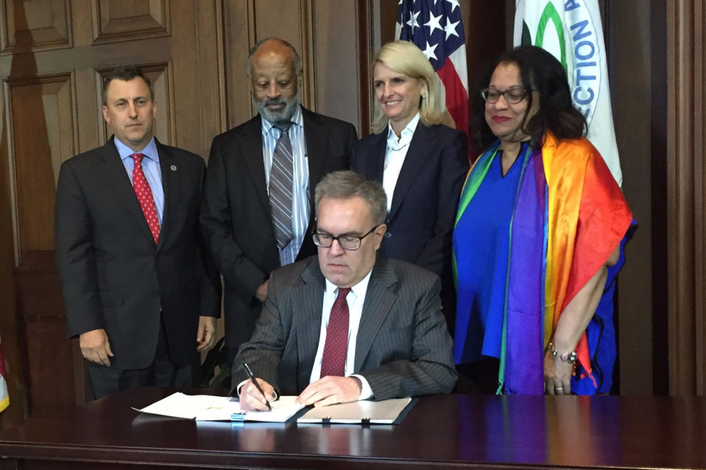 NRECA’s Kirk Johnson (far left) joins acting EPA Administrator Andrew Wheeler (seated) as he signs a proposal to rescind the 2015 rule for coal capture technology on new coal-based power plants. (Photo By: NRECA)