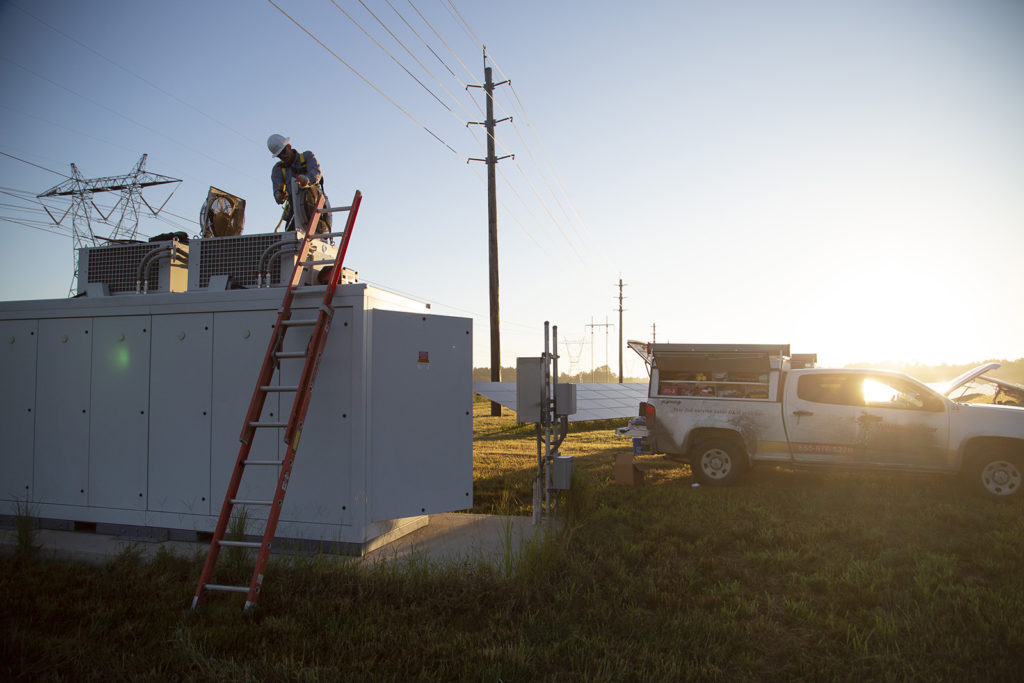 Contract technicians regularly perform preventive maintenance and system analyses on utility-scale solar arrays. (Photo By: Dennis Gainer/NRECA)