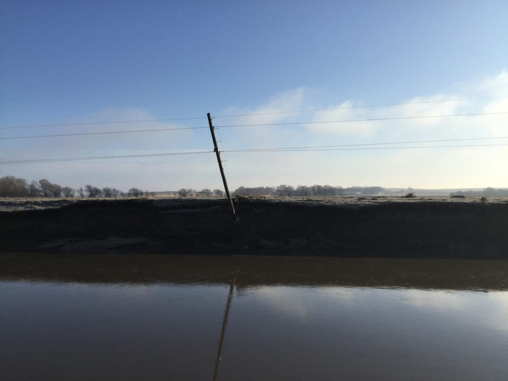 Crews from Cuming County Public Power District are expected to spend several weeks resetting poles and reinforcing pole bases once floodwaters recede in their territory. (Photo By: Cuming County PPD) 