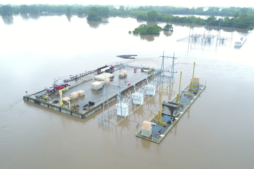 The Carl S. Whillock Hydroelectric Generating Station near Morrilton, Arkansas, is almost completely obscured by historic flooding along the Arkansas River. Switching stations on both river banks are also flooded. (Photo by: AECC)