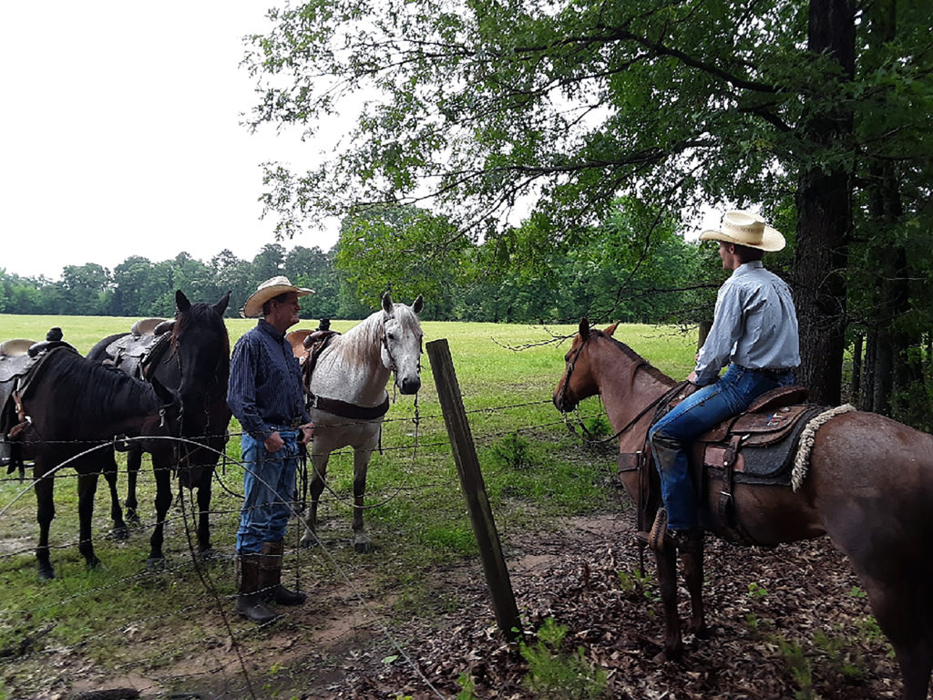 Co-op member Wade Beckham (left) supplied the horses when his son called with word that two Upshur RECC lineworkers couldn’t reach a downed line on his land to make repairs. (Photo By: Upshur RECC)