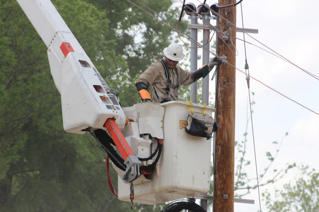 Apprentice line technician Jay Haskins of Gibson EMC installs a fiber connection to extend Gibson Connect high-speed broadband. (Photo By: Jenni Lynn Rachels/Gibson EMC)