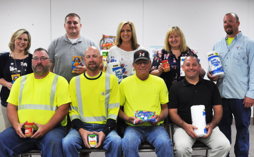 Eastern Illini EC employees (front row, left to right) Sean Miller, Jason Kocher, Keith Bergman, Brad Smith and (back row, left to right) Stacy Connor, Mark Classen, Shana Batte, Jeannine Wright, Luke Perzee collected food items for needy families facing the “summer slide.” (Photo By: EIEC)