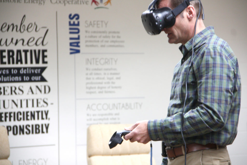 Using VR technology, Jo-Carroll Energy’s Mike Casper practices opening and closing a recloser on a remote substation. (Photo Courtesy: JCE)