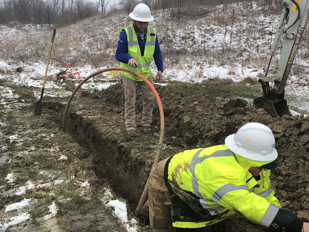 To meet a 72-hour deadline, a NineStar Connect crew manually digs the last 30 feet of an 1,800-foot conduit to deliver broadband to a medical clinic during the coronavirus pandemic. (Photo By: NineStar Connect)