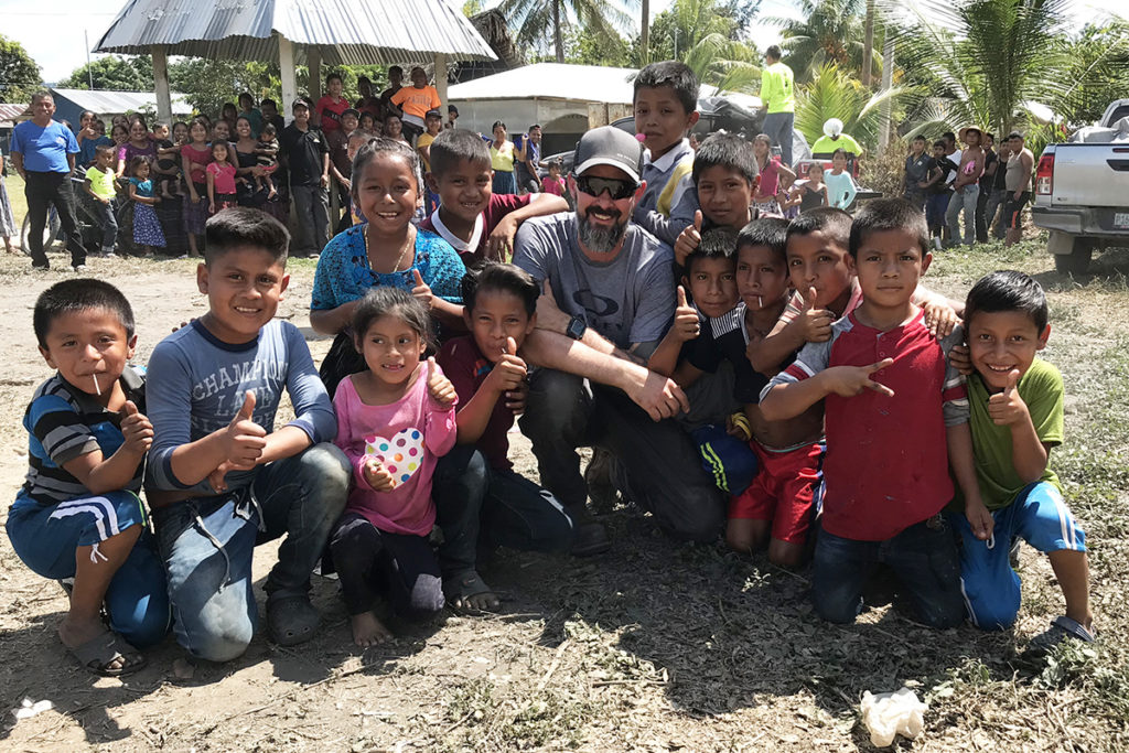 Jason McDermott, center, a field engineer with Ohio’s Electric Cooperatives, poses with Guatemalan children. (Photo Courtesy of Ohio’s Electric Cooperatives)