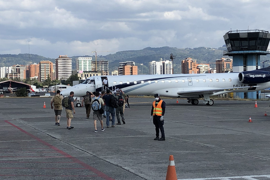 Ohio lineworkers board a charter plane at the Guatemala City airport to head back to the U.S. after Guatemala closed its borders and commercial flights were canceled in the midst of a widening coronavirus pandemic. Before leaving, they brought electricity to two remote villages. (Photo Courtesy of Ohio’s Electric Cooperatives)