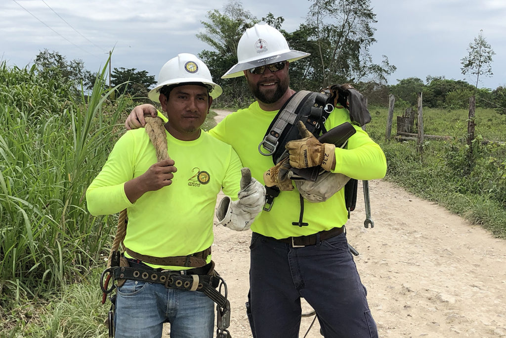 Jared Robinson, right, of Mid-Ohio Energy Cooperative in Marion, Ohio, is on the job with a Guatemalan lineworker. (Photo Courtesy of Ohio’s Electric Cooperatives)
