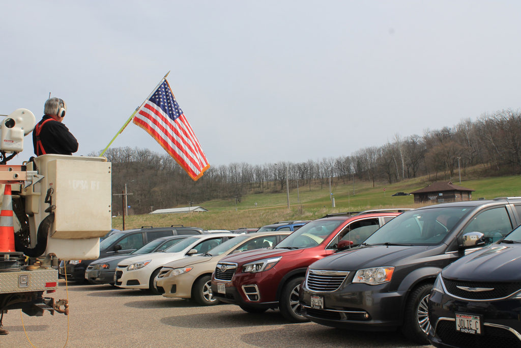 Cars shine their brights during the national anthem at the start of Richland Electric Co-op’s annual meeting. (Photo By: Alexis Dunnum/NRECA) 