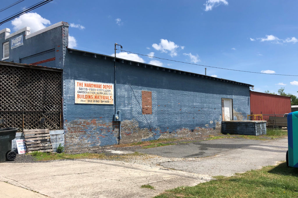 The bare wall of a pipeline company before a Flint Energies “Rural Murals” grant to Make Roberta-Crawford County Beautiful turned it into a work of art. (Photo By: Chris Johnson)