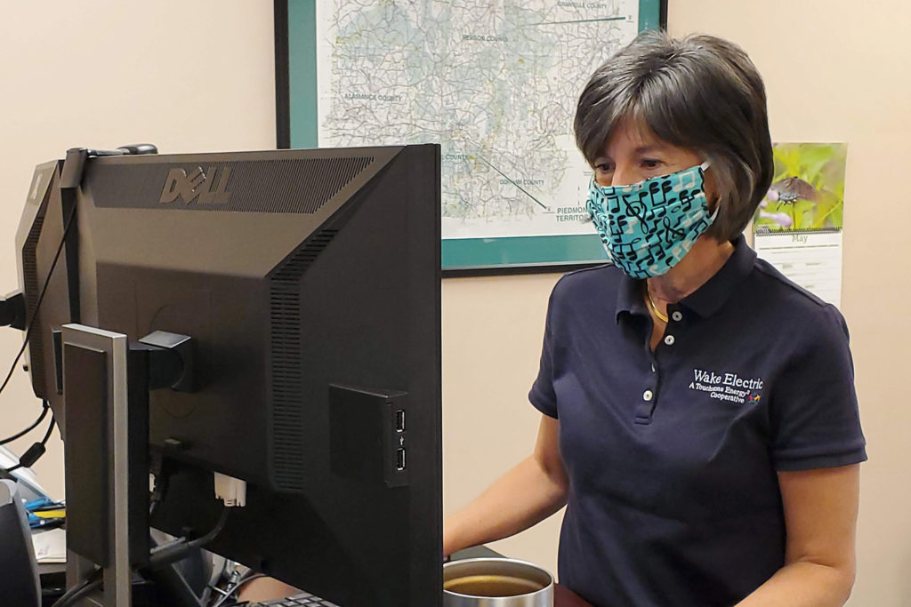 Lisa Kennedy is manager of financial services at Wake Electric. She has been using home-crafted face masks modified with metal strips to provide a more contoured fit around her mouth and nose. (Photo By: Rachel Benedict/ Piedmont EMC)