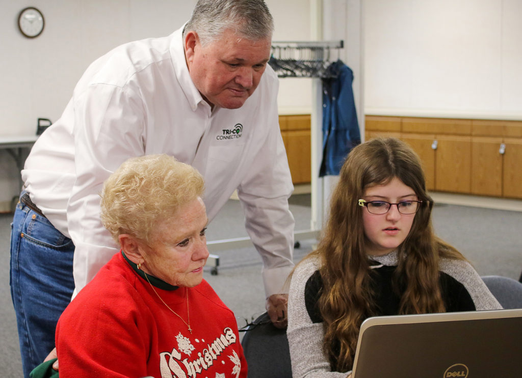 Tri-Co’s Bill Gerski joins an email lesson for Tri-County member Ernaline Hall (L) by Coudersport high schooler Darci Meacham (R) in a Seniors 2 Seniors class, the co-op’s brainchild to get retirees—42% of their membership—broadband ready. (Photo By: Jim Fetzer/Tri-County REC)