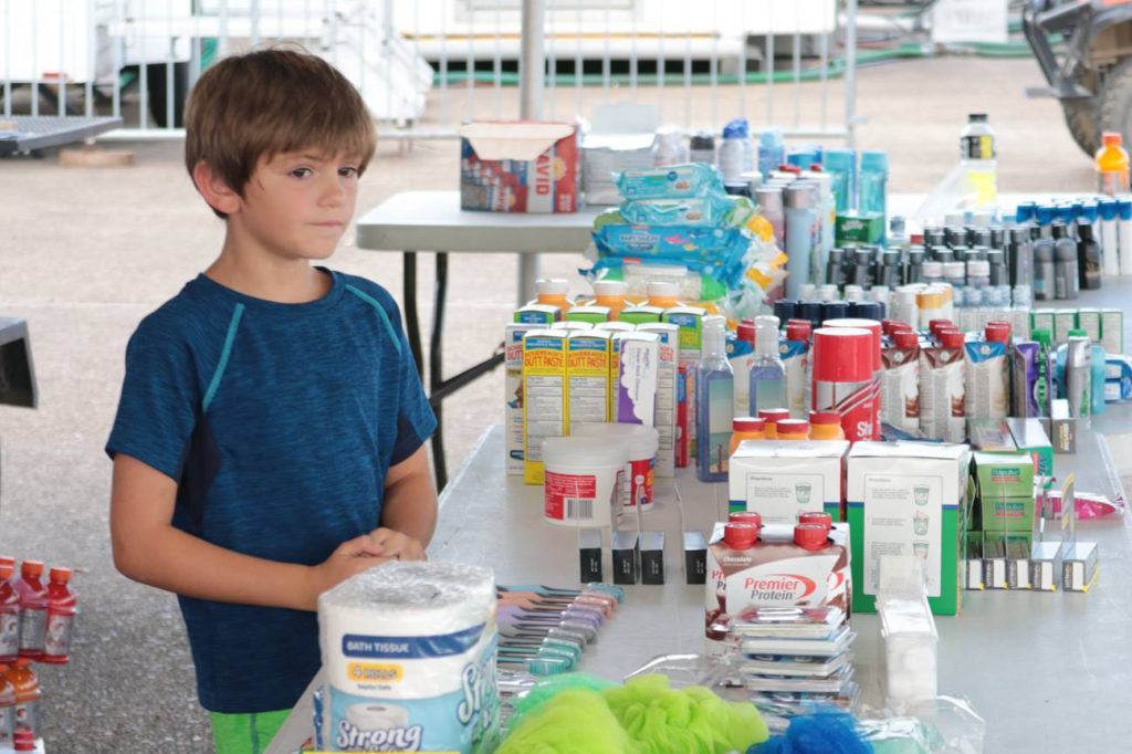 Louisiana co-op members have shown visiting crews generosity and appreciation despite the hardship of being without power for weeks. Here, the son of a Jeff Davis Electric Co-op employee attends a table of donated toiletries and other supplies meant for out-of-state restoration teams. (Photo By: Addie Armato)