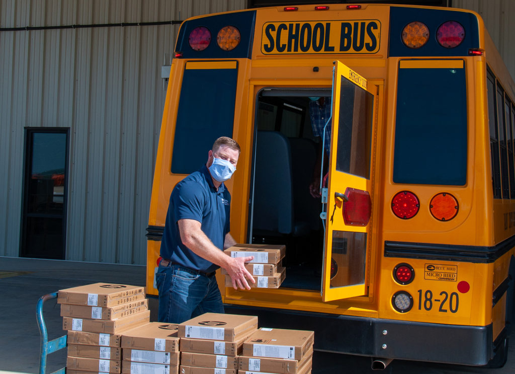 Flint Energies Manager of Information Technology Todd Bigler loads 45 Chromebooks into a Talbot County Schools bus to be delivered to students in need. The co-op bought $90,000 worth of these tablets to assist in distance learning this year. (Photo By: Hannah Sloan/Flint Energies)