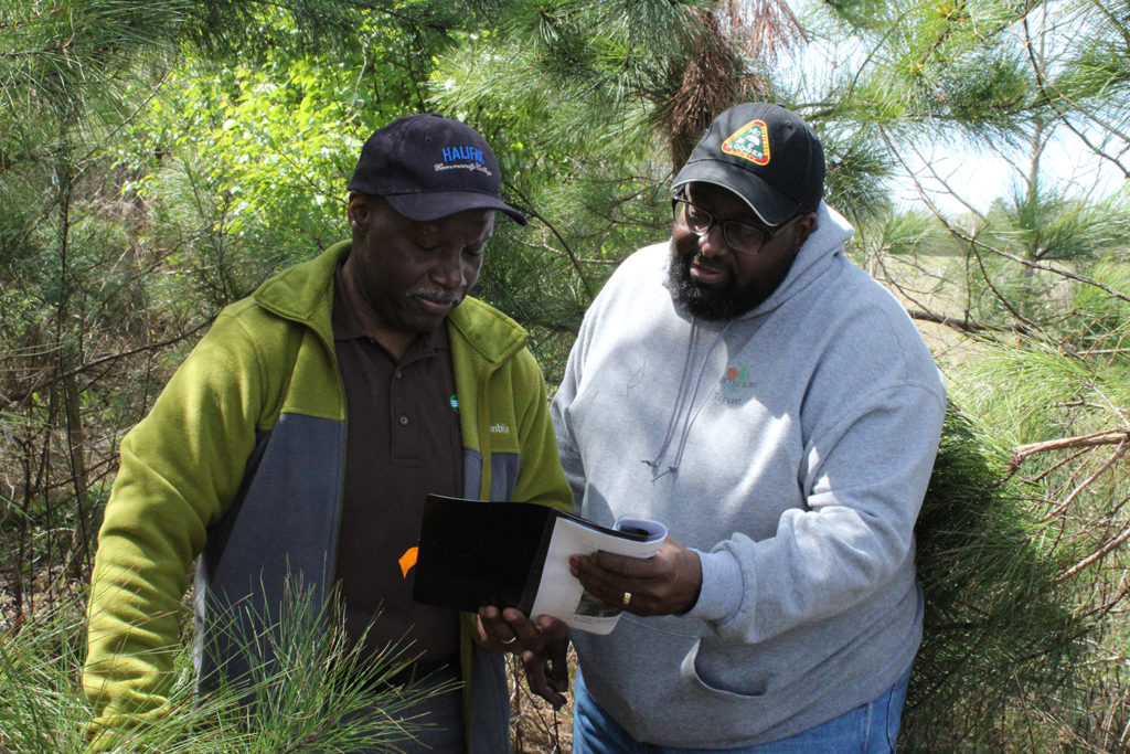 Fourtee Acres Farms’ Tyrone Williams (r) has been a longtime participant in Roanoke Electric Cooperative’s sustainable forestry project. At left is REC’s Alton Perry. (Photo Courtesy: North Carolina Forestry Deptartment) 
