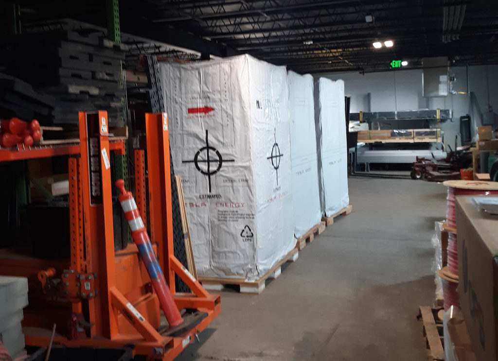 PVREA keeps the battery system for the Red Feather Lakes microgrid under wraps until it can be installed in late October. The  Rocky Mountain hamlet is currently threatened by the Cameron Peak Fire. (Photo Courtesy of PVREA)